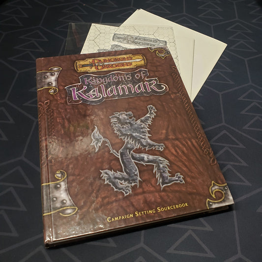 Image shows the front cover of the Kingdoms of Kalamar: Campaign Setting roleplaying game book with the map and transparency inserts fanned out