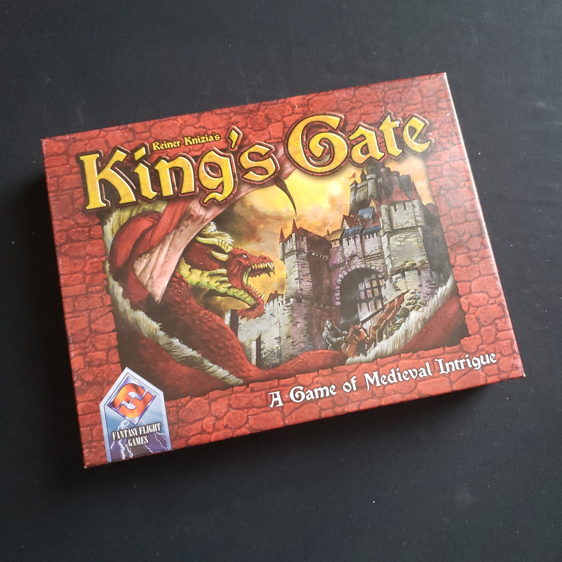 Image shows the front cover of the box of the King's Gate board game