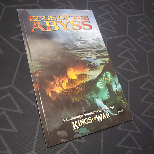 Image shows the front cover of the Kings of War 2E: Edge of the Abyss wargaming book