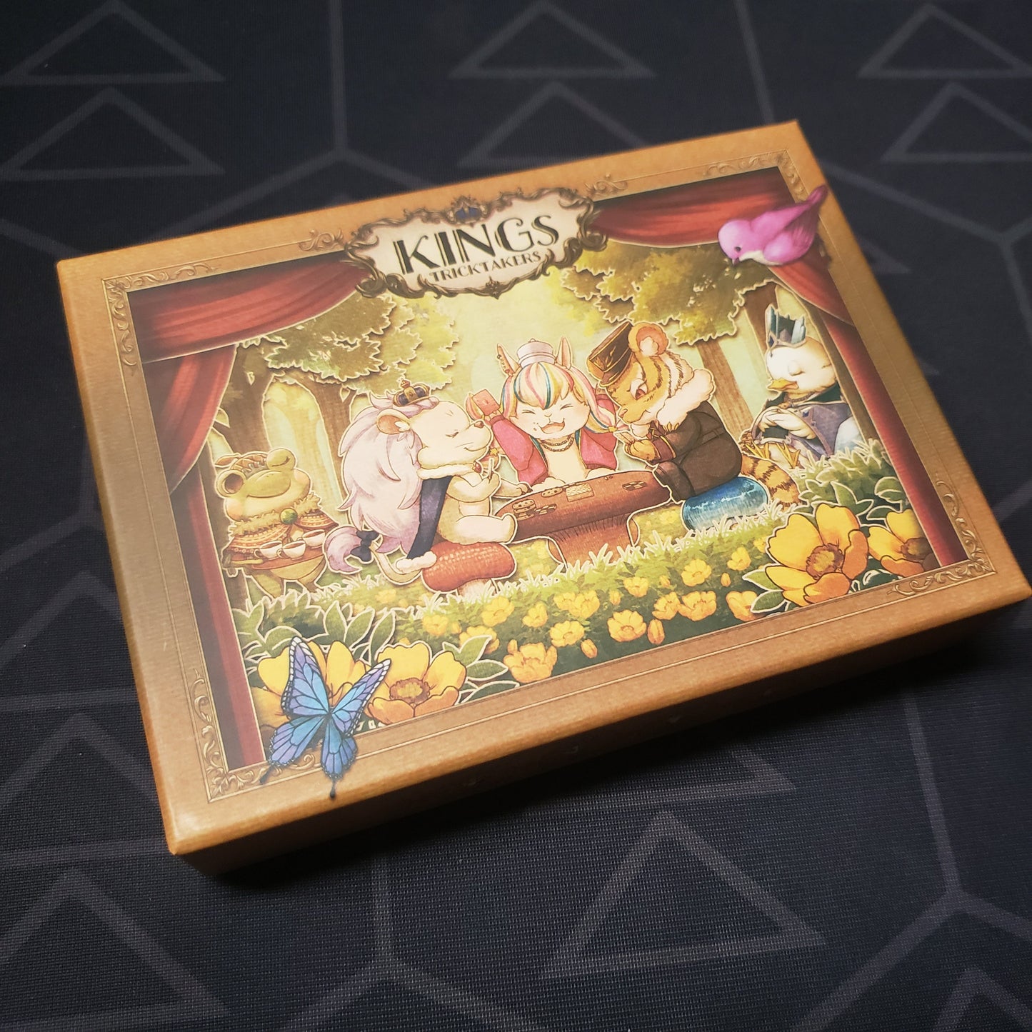 Image shows the front cover of the box for the KINGs: TRICKTAKERs (Compact Edition) card game