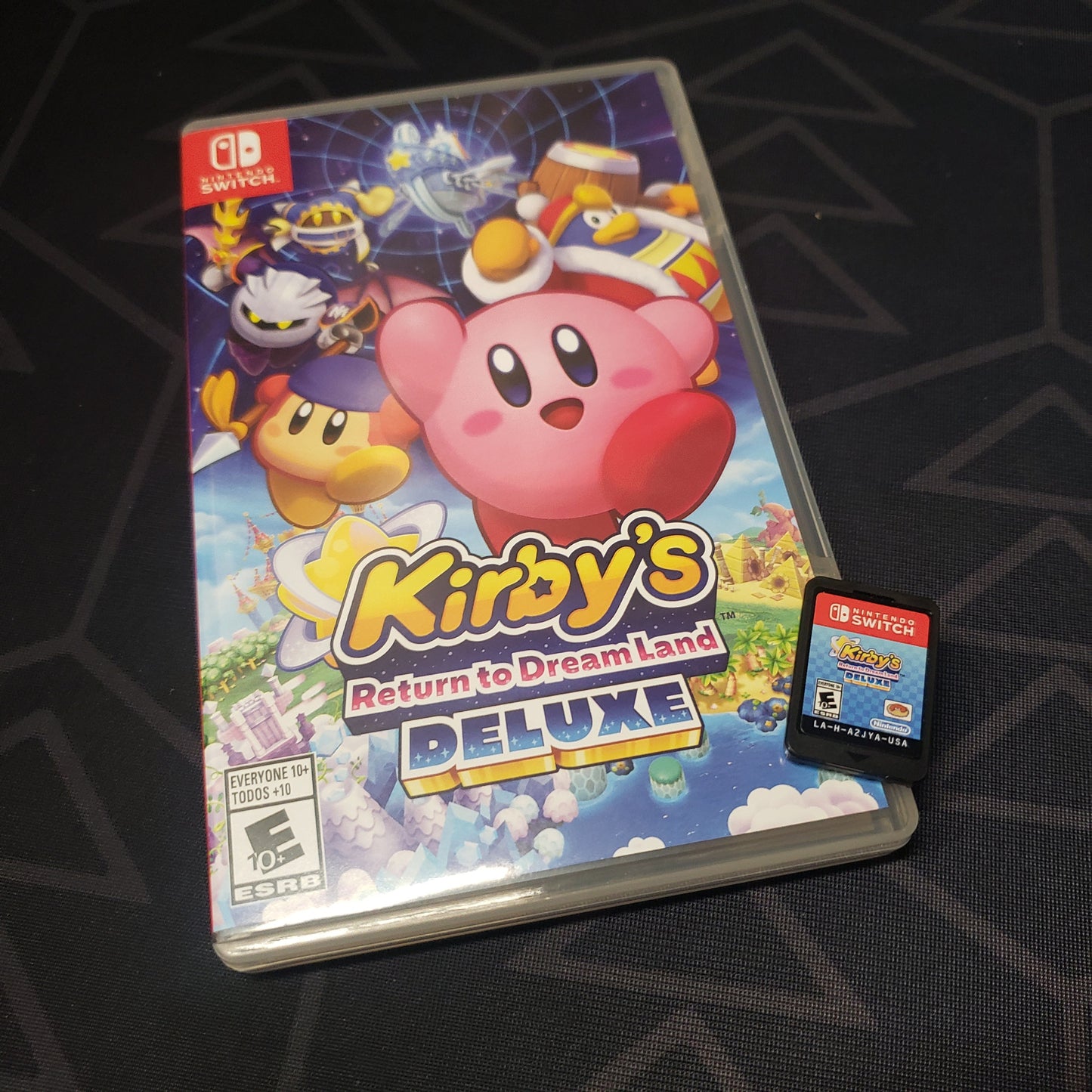 Image shows the case & cartridge for the video game Kirby's Return to Dreamland Deluxe for Nintendo Switch