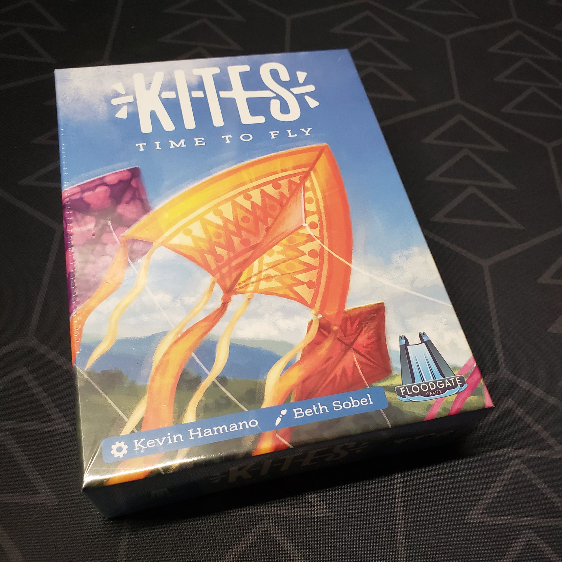 Image shows the front cover of the box of the Kites card game