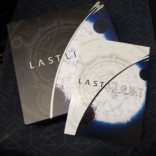 Image shows the front cover of the Deluxe Edition box for the board game Last Light with the instruction manual for the Infinity expansion