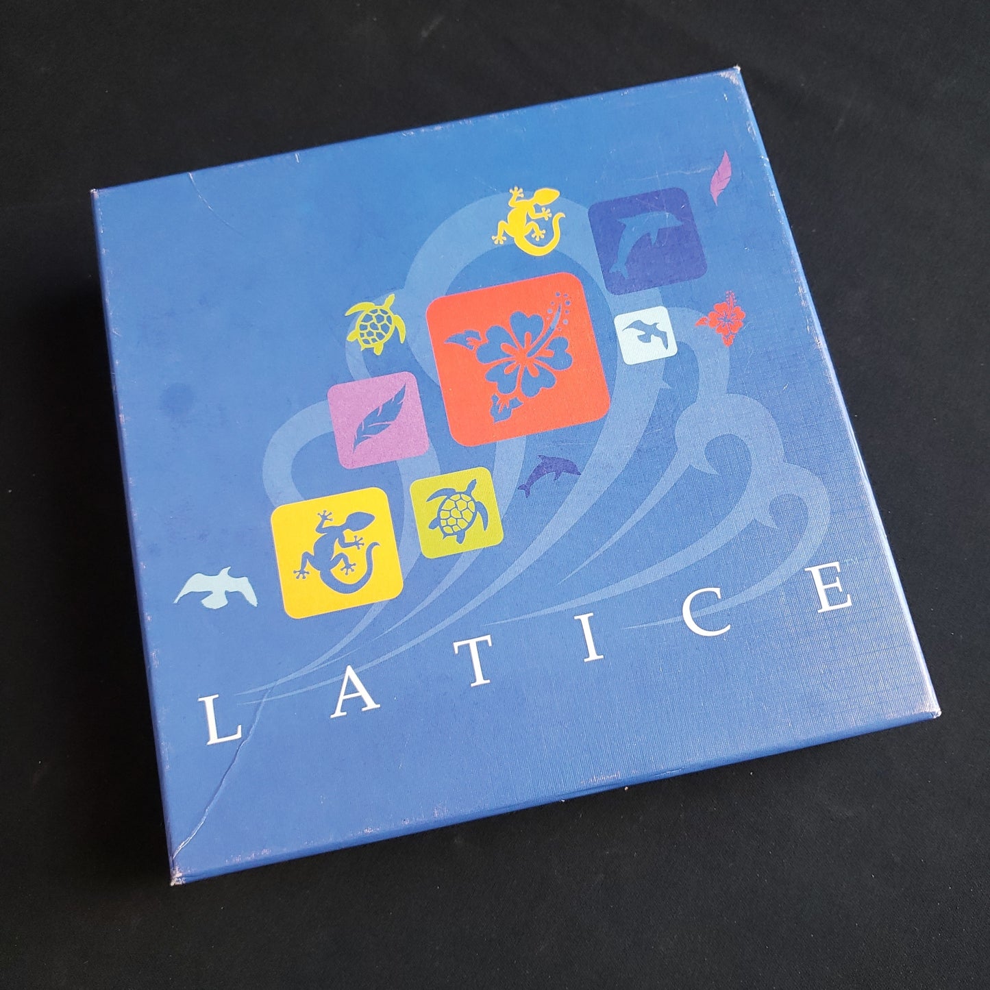 Image shows the front cover of the box of the Latice board game