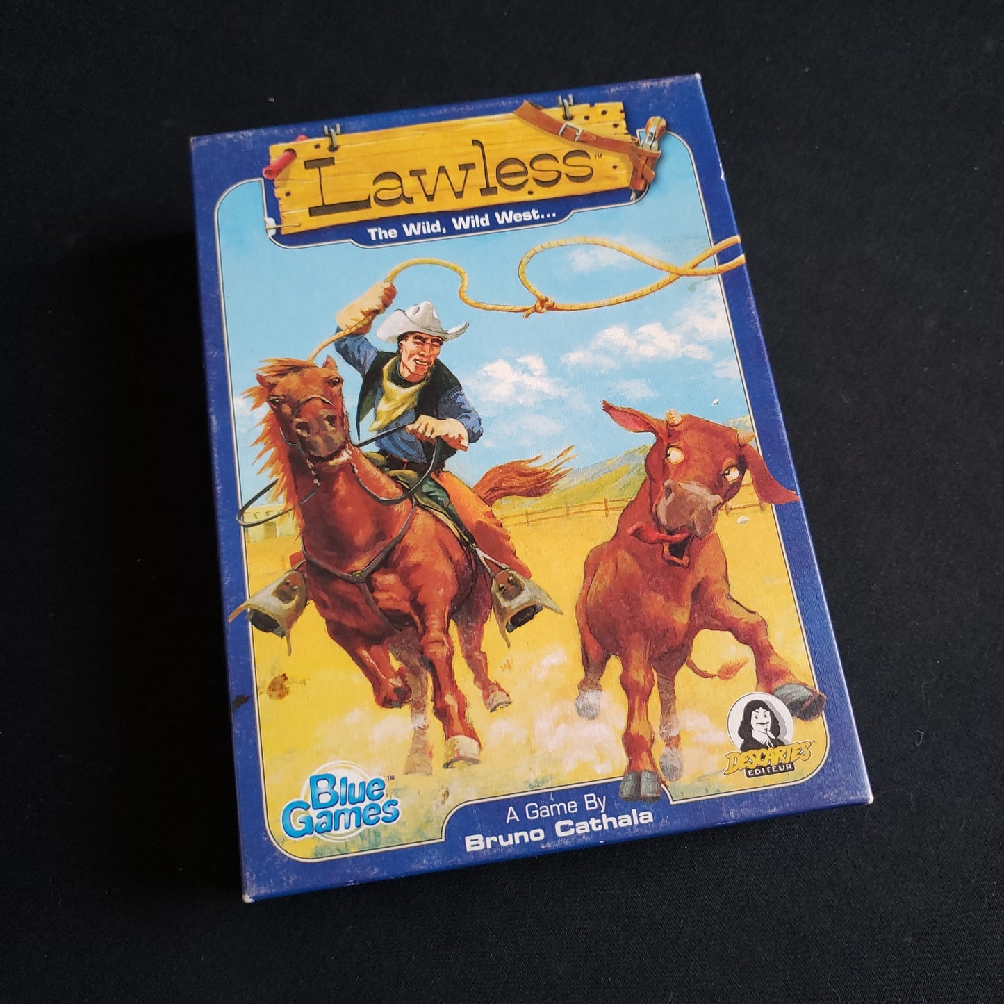 Image shows the front cover of the box of the Lawless card game