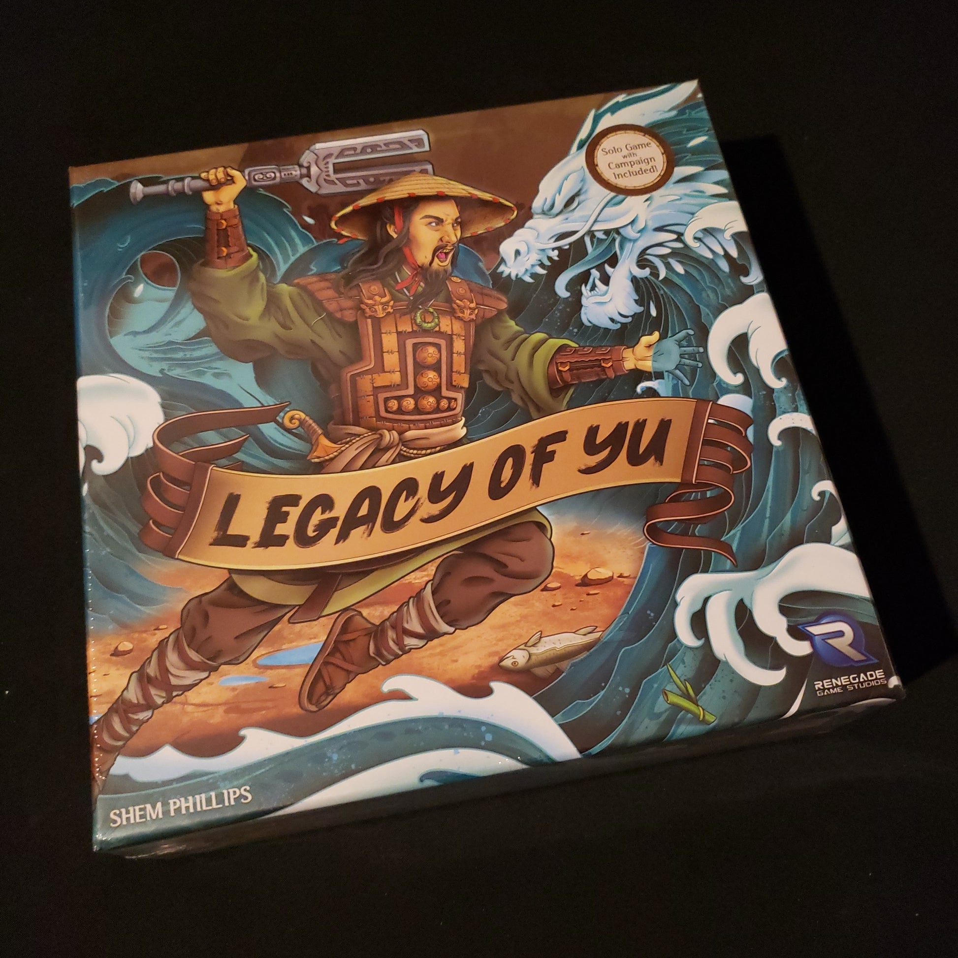 Image shows the front cover of the box of the Legacy of Yu board game