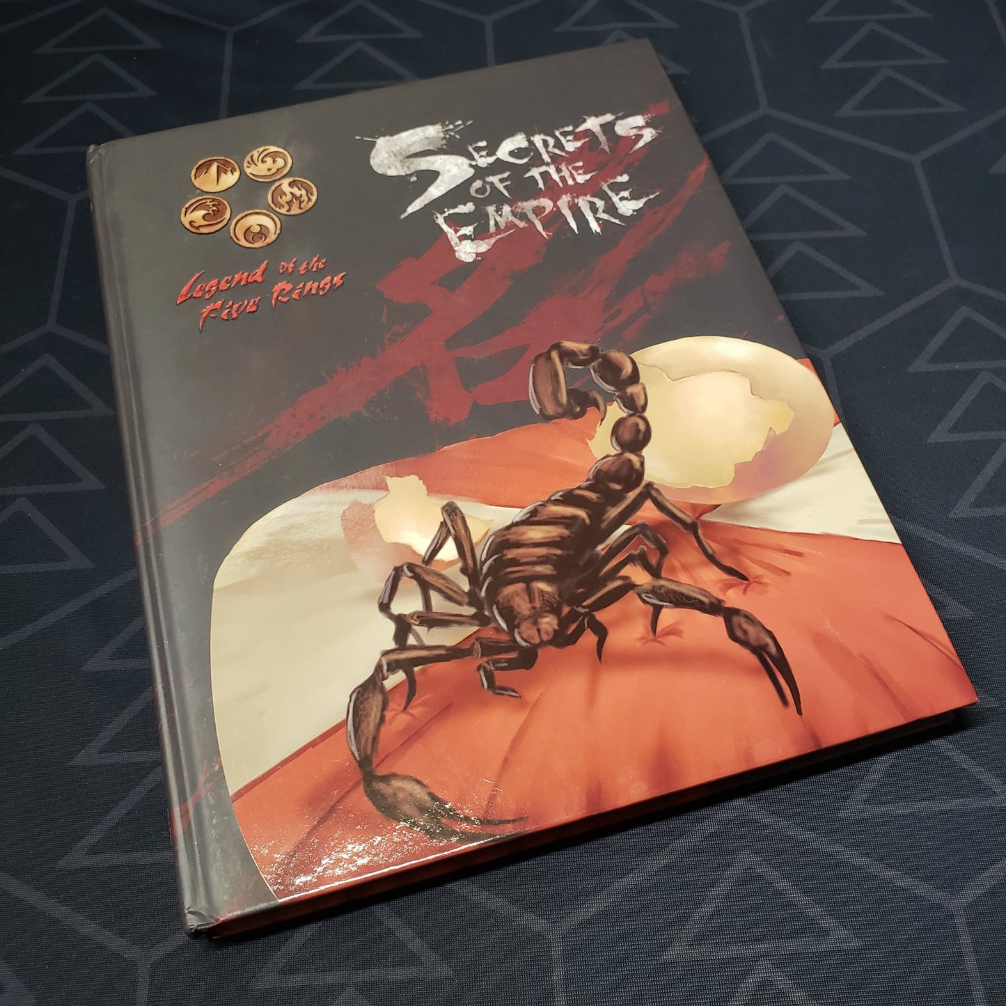 Image shows the front cover of the Secrets of the Empire book for the roleplaying game Legend of the Five Rings: Fourth Edition