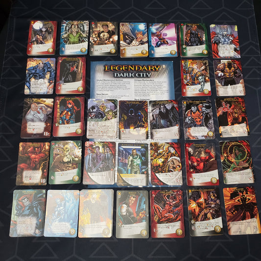 Image shows the instructions & cards arranged in stacks by card type for the Dark City expansion for the card game Legendary Marvel