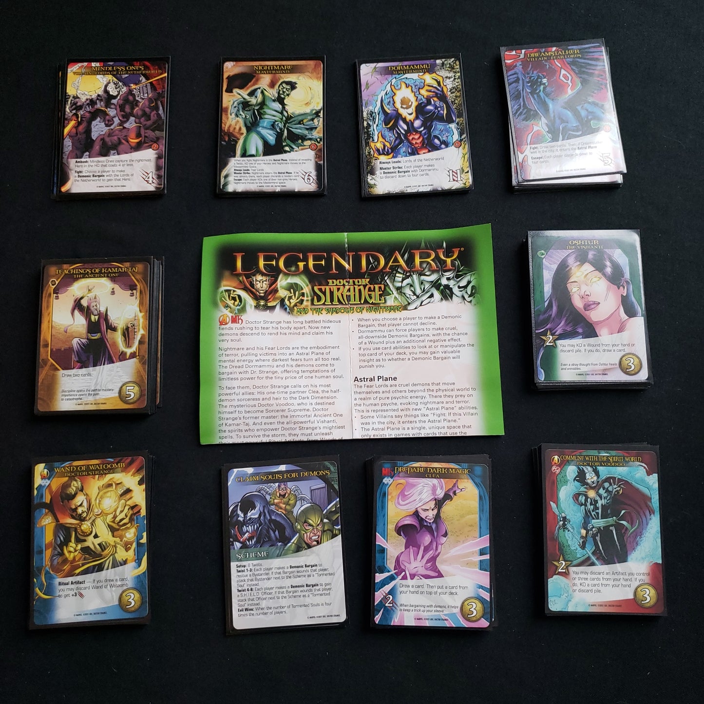 Image shows the instructions & cards arranged in stacks by card type for the Dr. Strange and the Shadows of Nightmare expansion for the board game Legendary Marvel