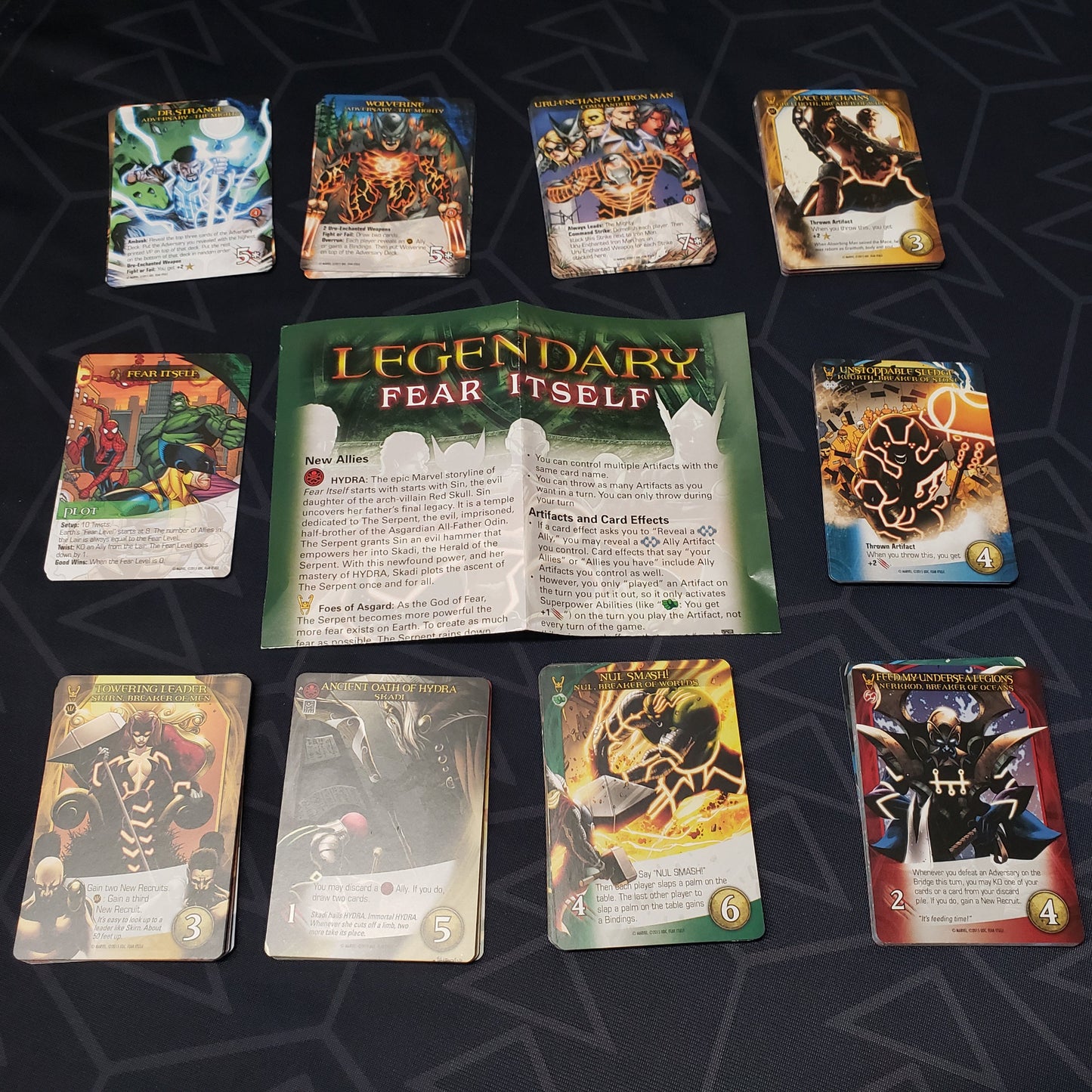 Image shows instructions & cards arranged in stacks by card type for the Fear Itself expansion for the card game Legendary Marvel