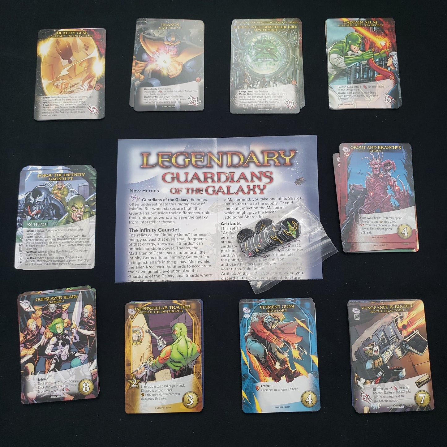 Image shows the instructions & cards arranged in stacks by card type for the Guardians of the Galaxy expansion for the board game Legendary Marvel