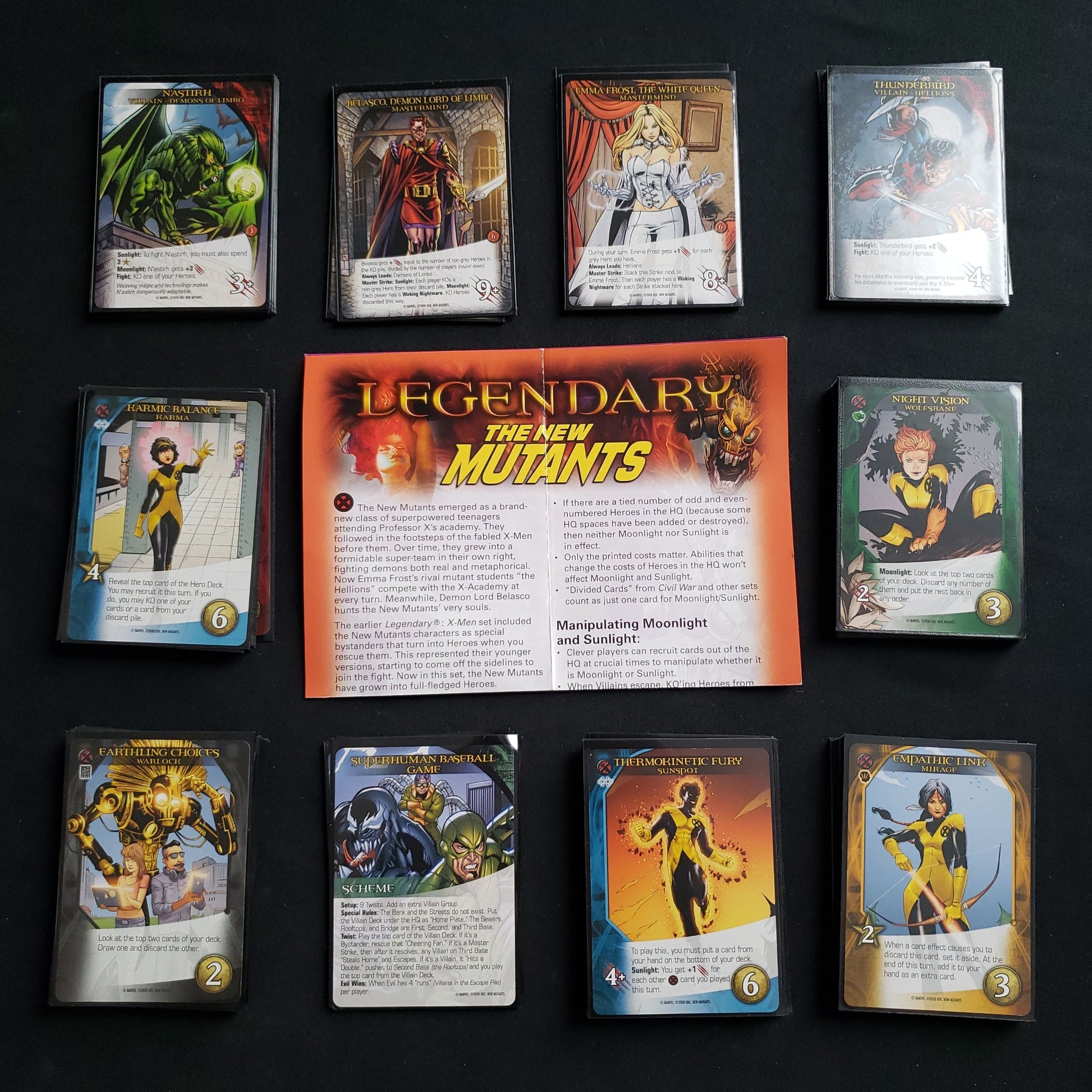 Image shows the instructions & cards arranged in stacks by card type for the New Mutants expansion for the board game Legendary Marvel