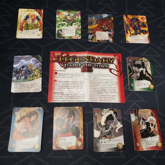 Image shows the instructions & cards arranged in stacks by card type for the Paint the Town Red expansion for the board game Legendary Marvel