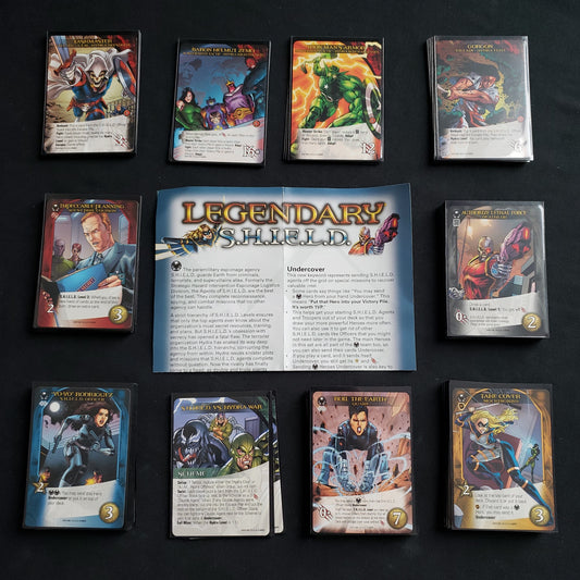 Image shows the instructions & cards arranged in stacks by card type for the S.H.I.E.L.D. expansion for the board game Legendary Marvel