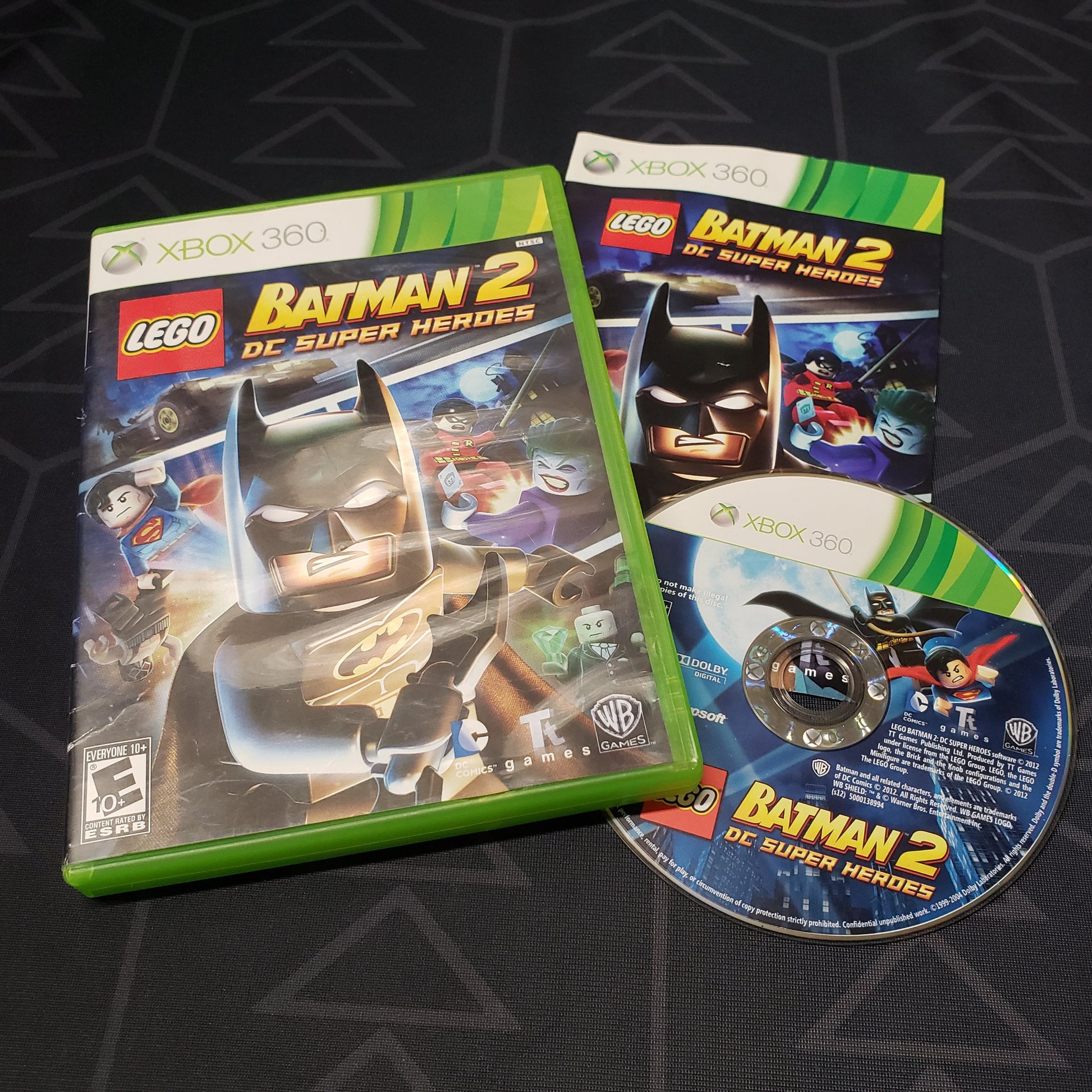 Image shows the case, manual and disc for the video game LEGO Batman 2: DC Super Heroes for Xbox 360