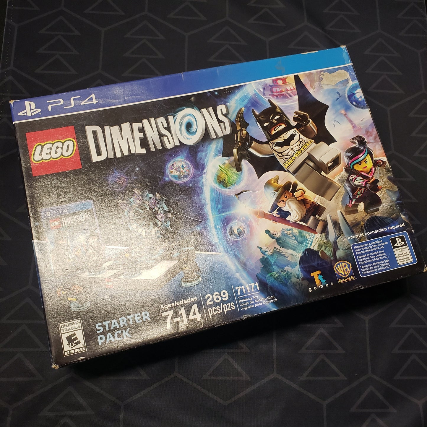 Image shows the front of the Starter Pack box for the video game LEGO Dimensions for Playstation 4