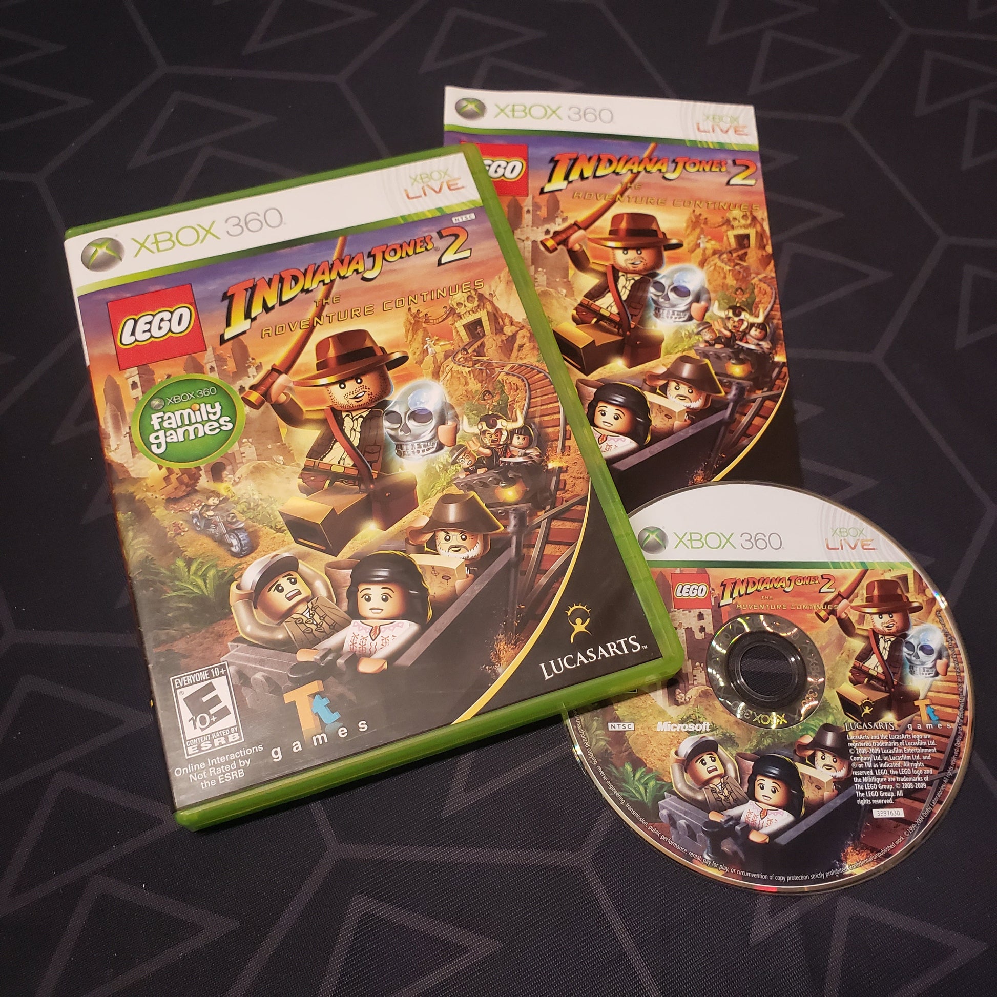 Image shows the case, manual and disc for the video game LEGO Indiana Jones 2: The Adventure Continues for Xbox 360