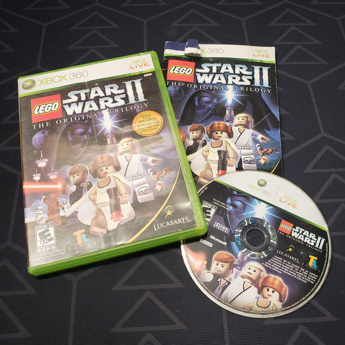 Image shows the case, manual and disc for the video game LEGO Star Wars II: The Original Trilogy for Xbox 360