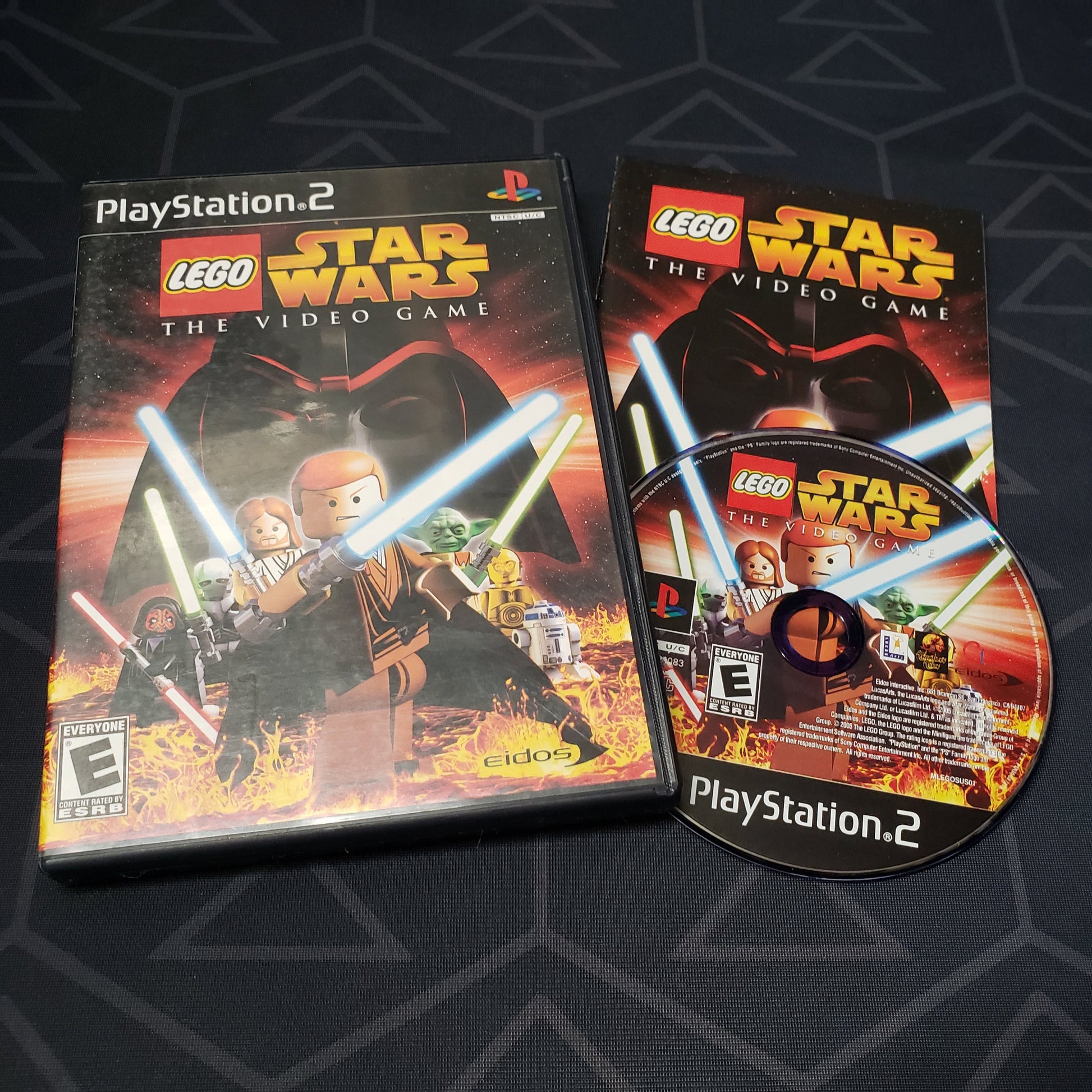 Image shows the case, manual and disc for the video game LEGO Star Wars: The Video Game for Playstation 2