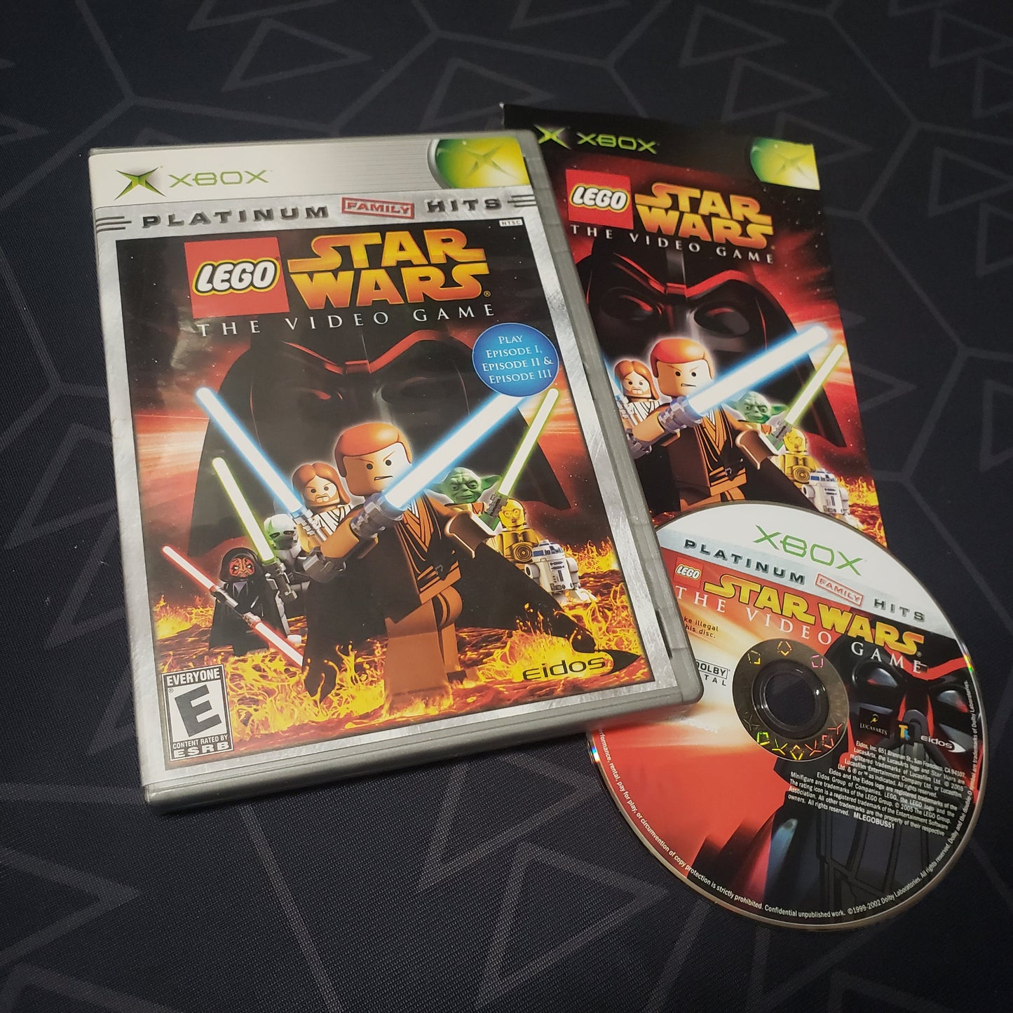 Image shows the case, manual and disc for the video game LEGO Star Wars: The Video Game for the original Xbox
