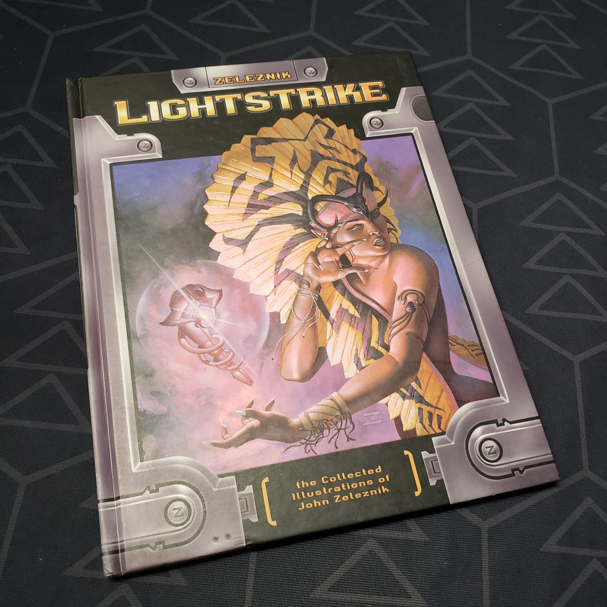 Image shows the front cover of the Lightstrike: The Collected Illustrations of John Zeleznik roleplaying game art book