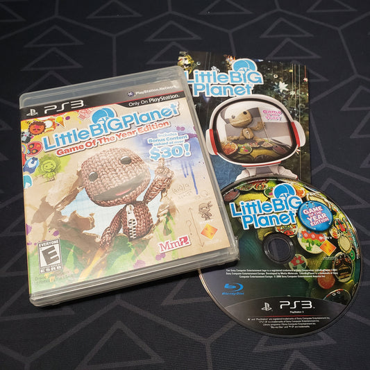 Image shows the case, manual and disc for the video game LittleBigPlanet: Game of the Year Edition for Playstation 3