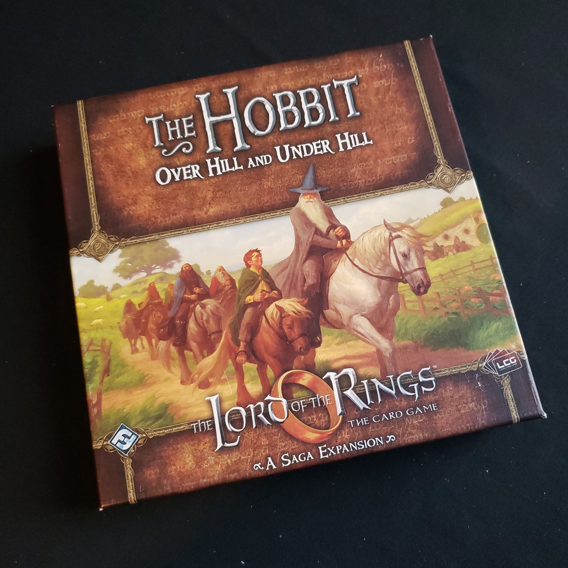 Image shows the front of the box for the Hobbit: Over Hill & Under Hill Saga Expansion for the Lord of the Rings card game