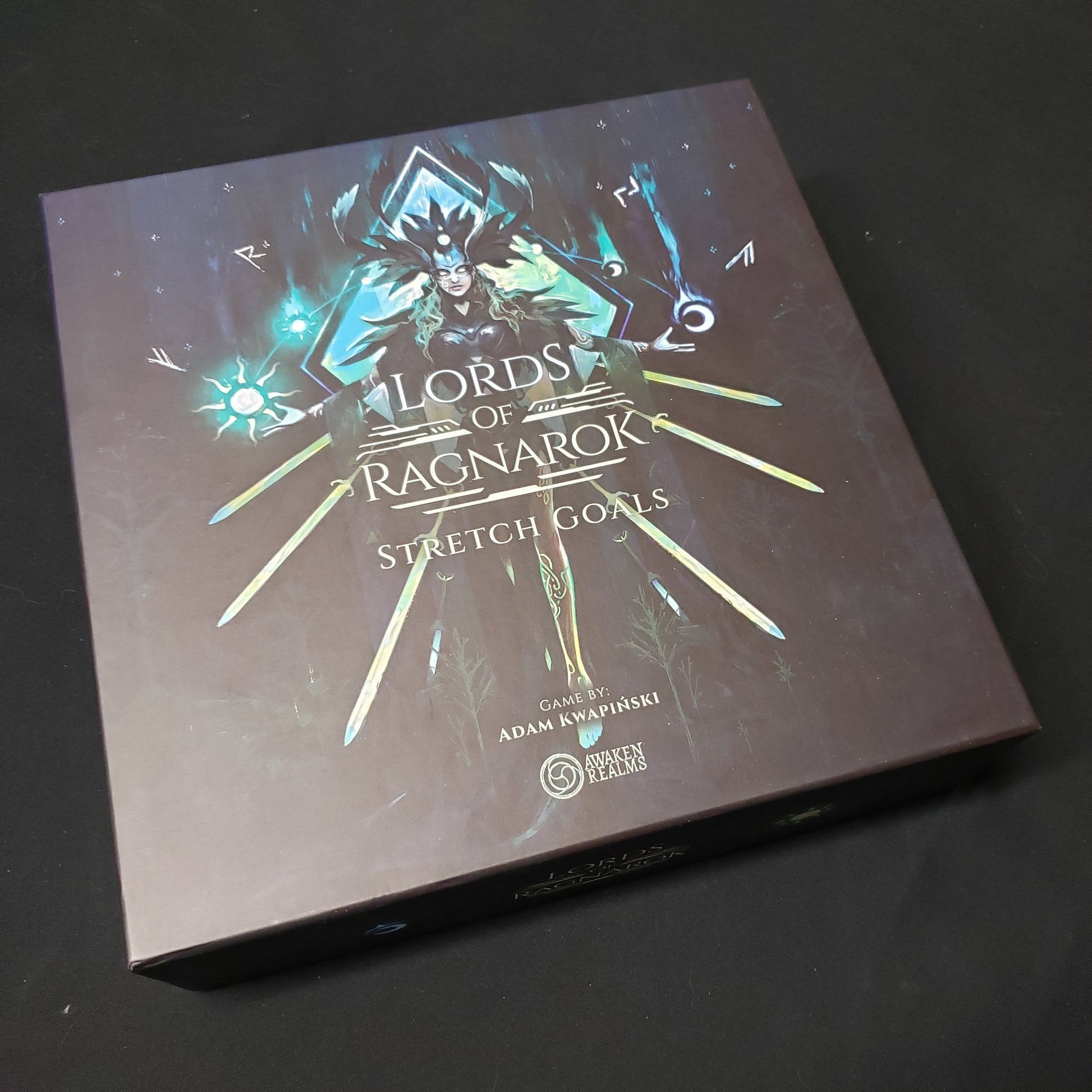 Image shows the front cover of the box of the Stretch Goals expansion for the board game Lords of Ragnarok