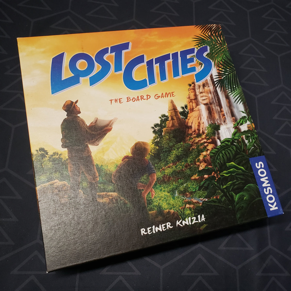 Image shows the front cover of the box for Lost Cities: The Board Game