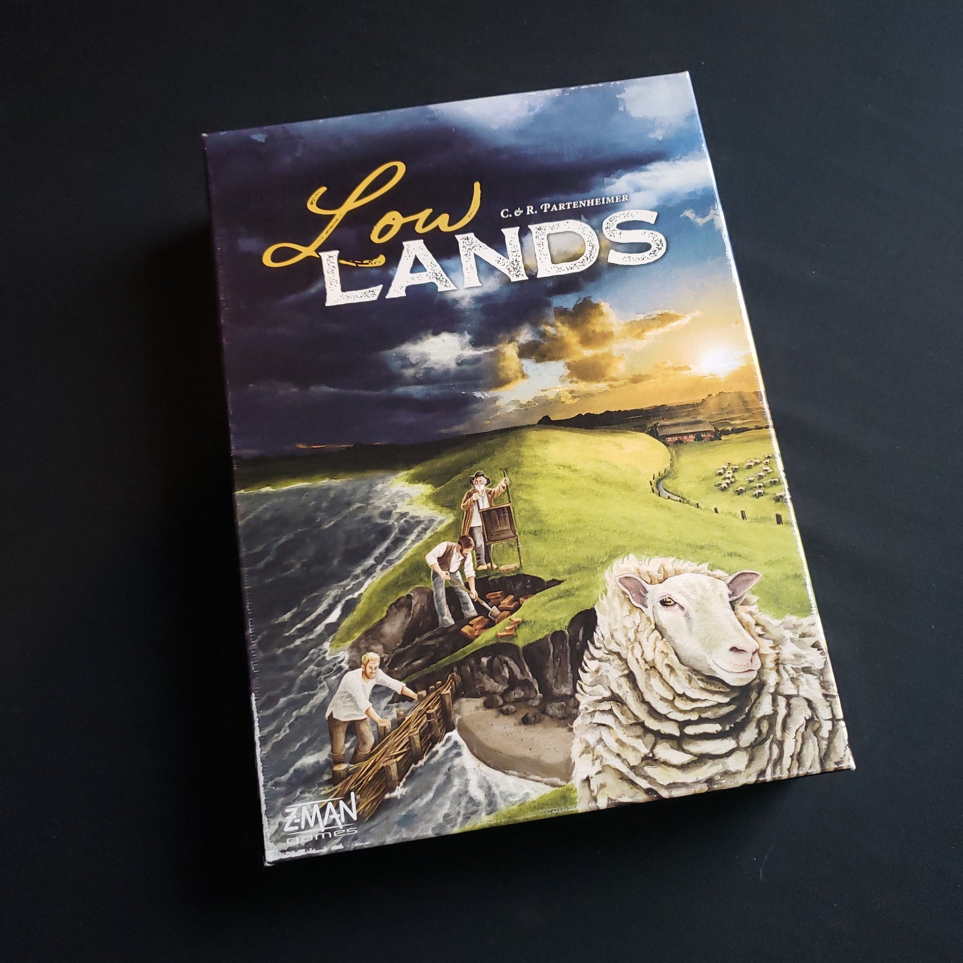 Image shows the front cover of the box of the Lowlands board game