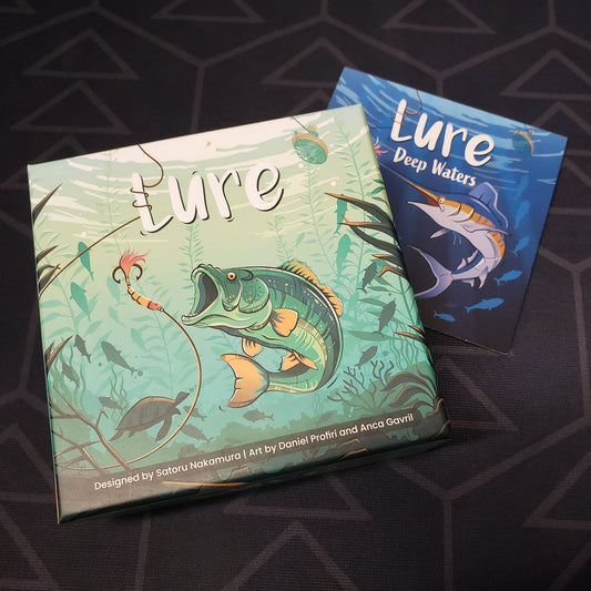 Image shows the front cover of the box for the Lure card game, sitting on top of the instructions for the Deep Waters expansion