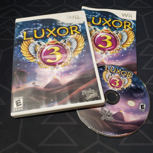 Image shows the case, manual and disc for the video game Luxor 3 for Nintendo Wii