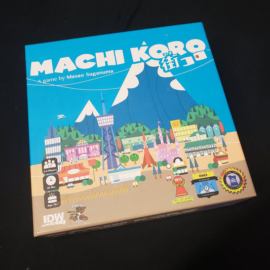 Image shows the front cover of the box of the Machi Koro board game