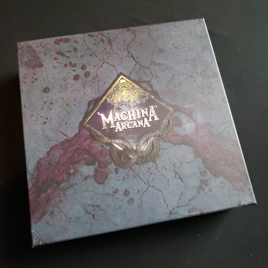 Image shows the front cover of the box of the Machina Arcana board game