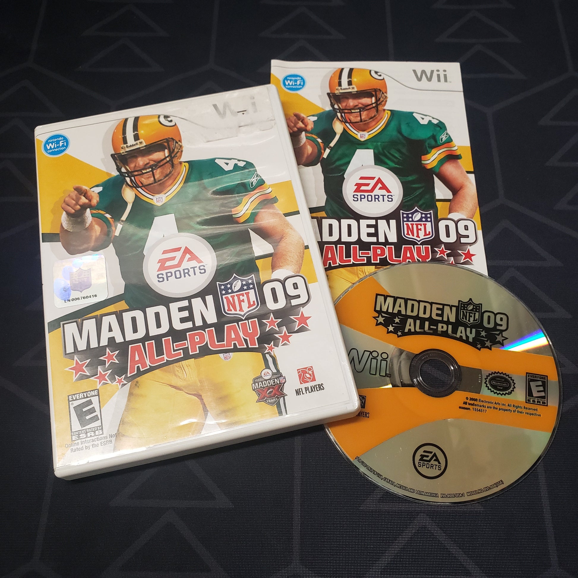 Image shows the case, manual and disc for the video game Madden NFL 09 All-Play for Nintendo Wii