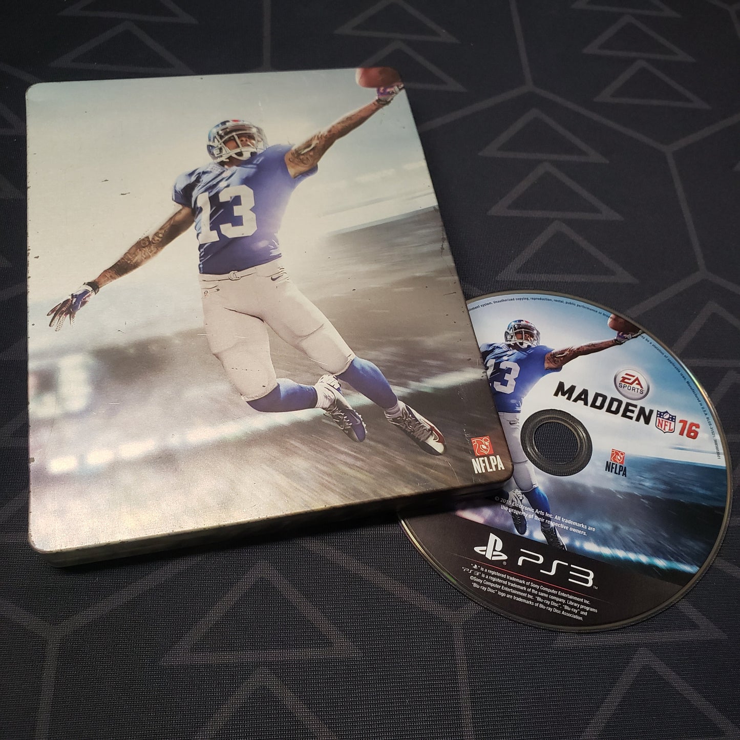 Image shows the steelbook case and disc for the video game Madden NFL 16 for Playstation 3