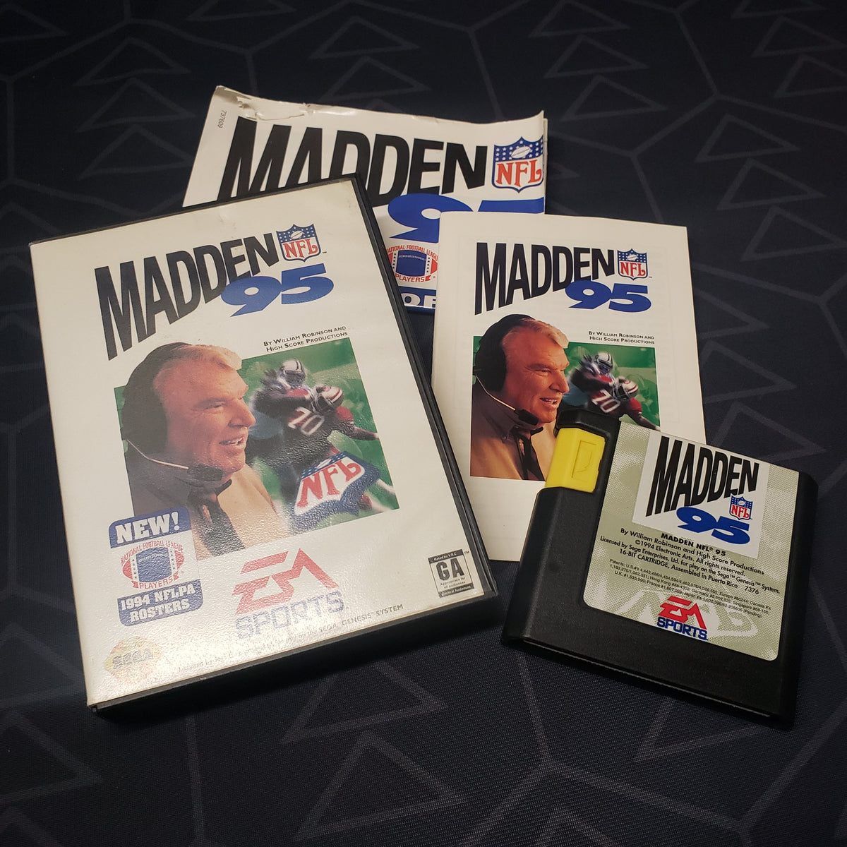 Image shows the case, manual, poster and cartridge for the video game Madden NFL 95 for Sega Genesis