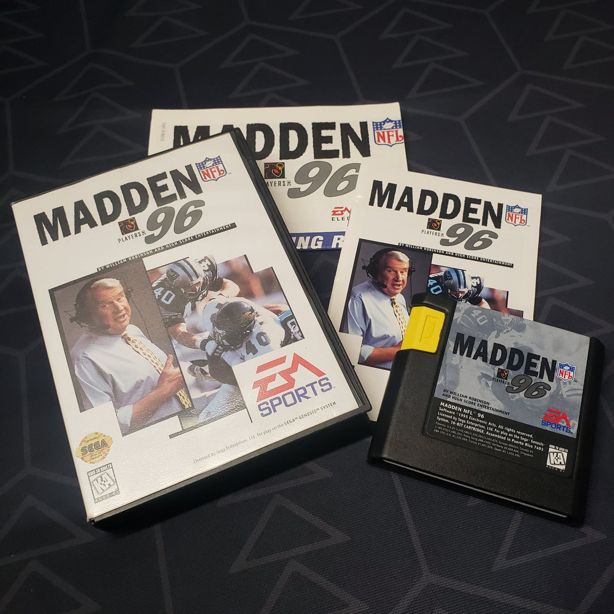 Image shows the case, manual, poster and cartridge for the video game Madden NFL 96 for Sega Genesis