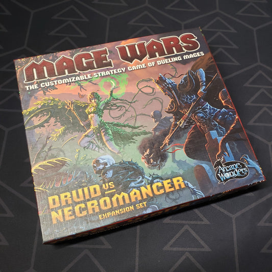 Image shows the front cover of the box of the Druid vs. Necromancer expansion for the board game Mage Wars