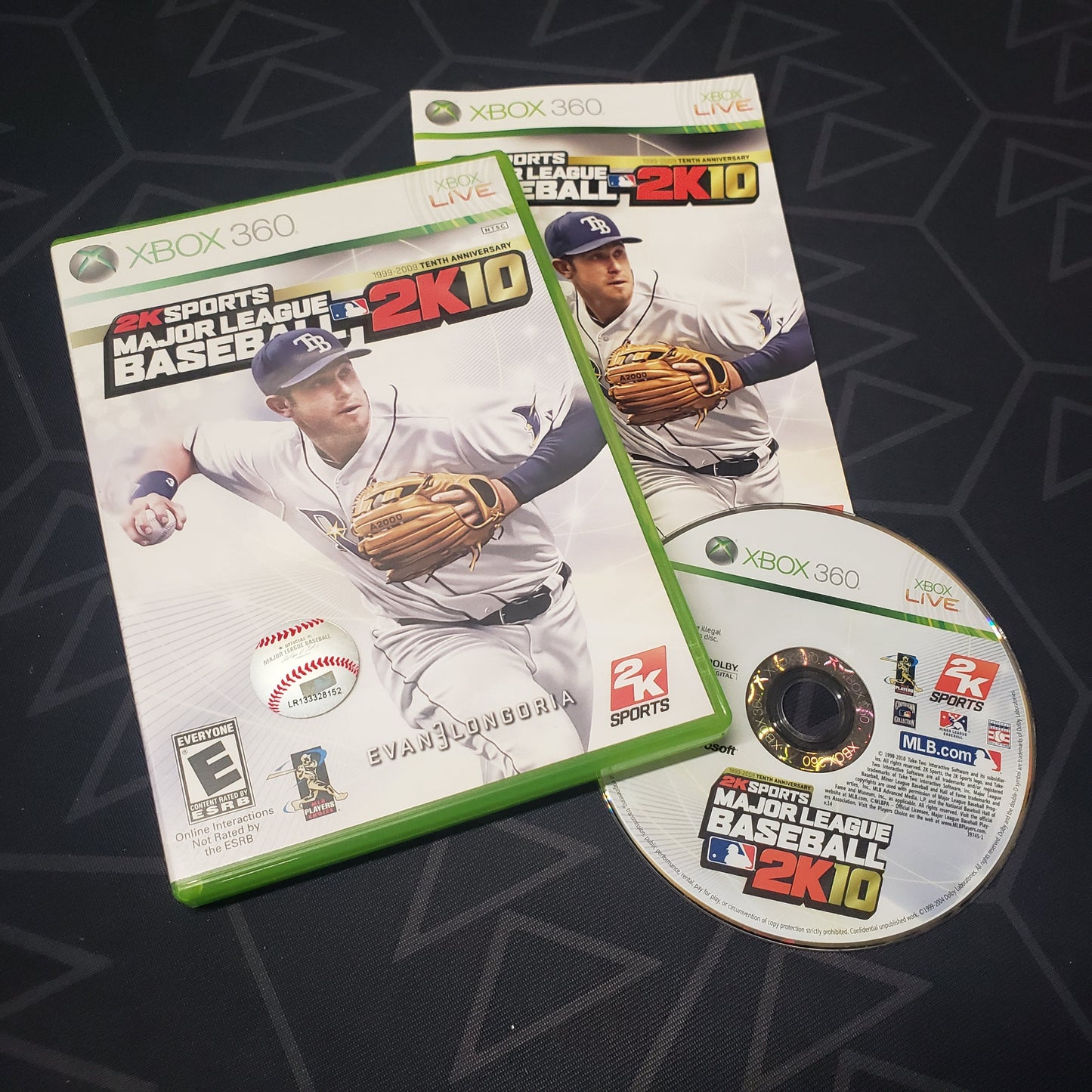 Image shows the case, manual and disc for the video game Major League Baseball 2K10 for Xbox 360