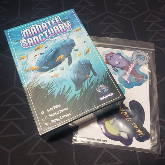 Image shows the front cover of the box for the Manatee Sanctuary (Seacow Edition) board game sitting on top of a bonus sticker pack