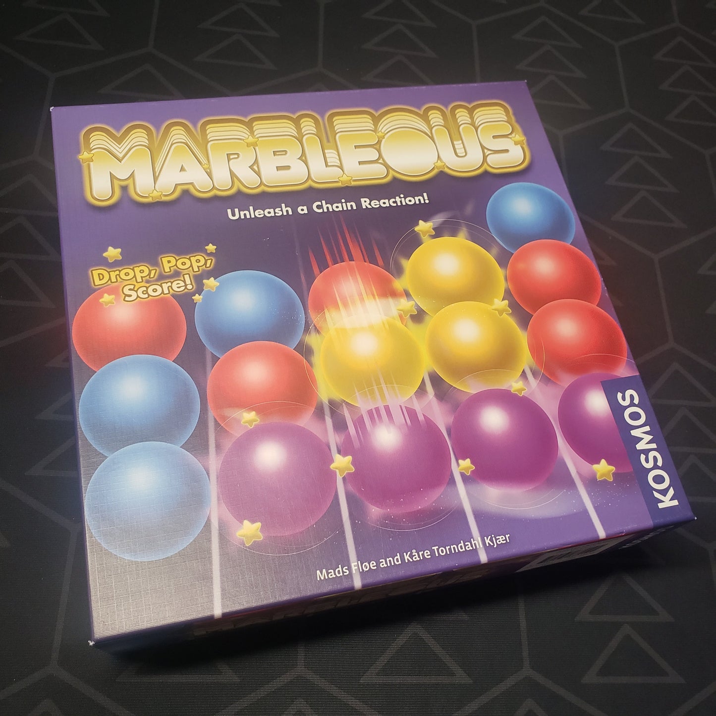 Image shows the front cover of the box for the Marbleous board game