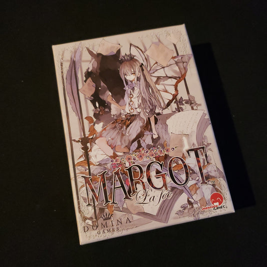 Image shows the front cover of the box of the card game Margot: La fee