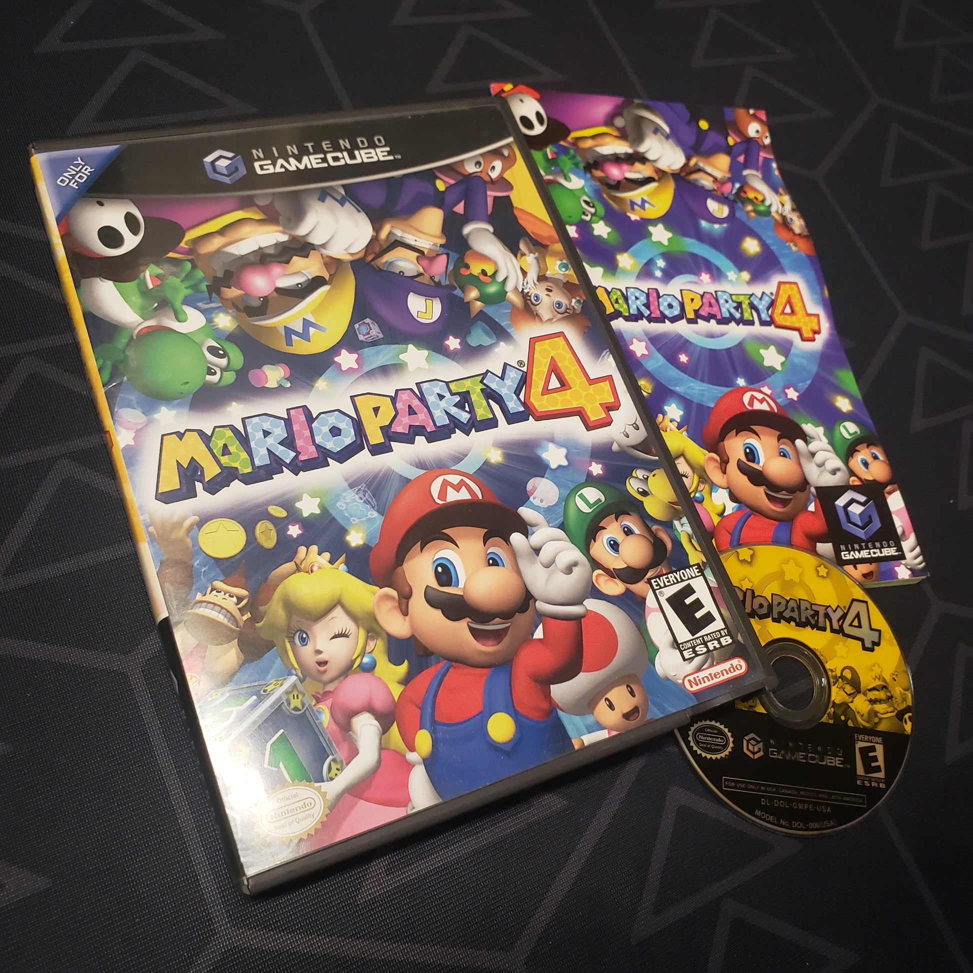 Image shows the case, manual and disc for the video game Mario Party 4 for Nintendo GameCube