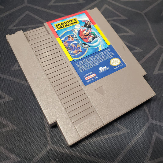 Image shows the front of the cartridge for the video game Mario's Time Machine for the Nintendo Entertainment System