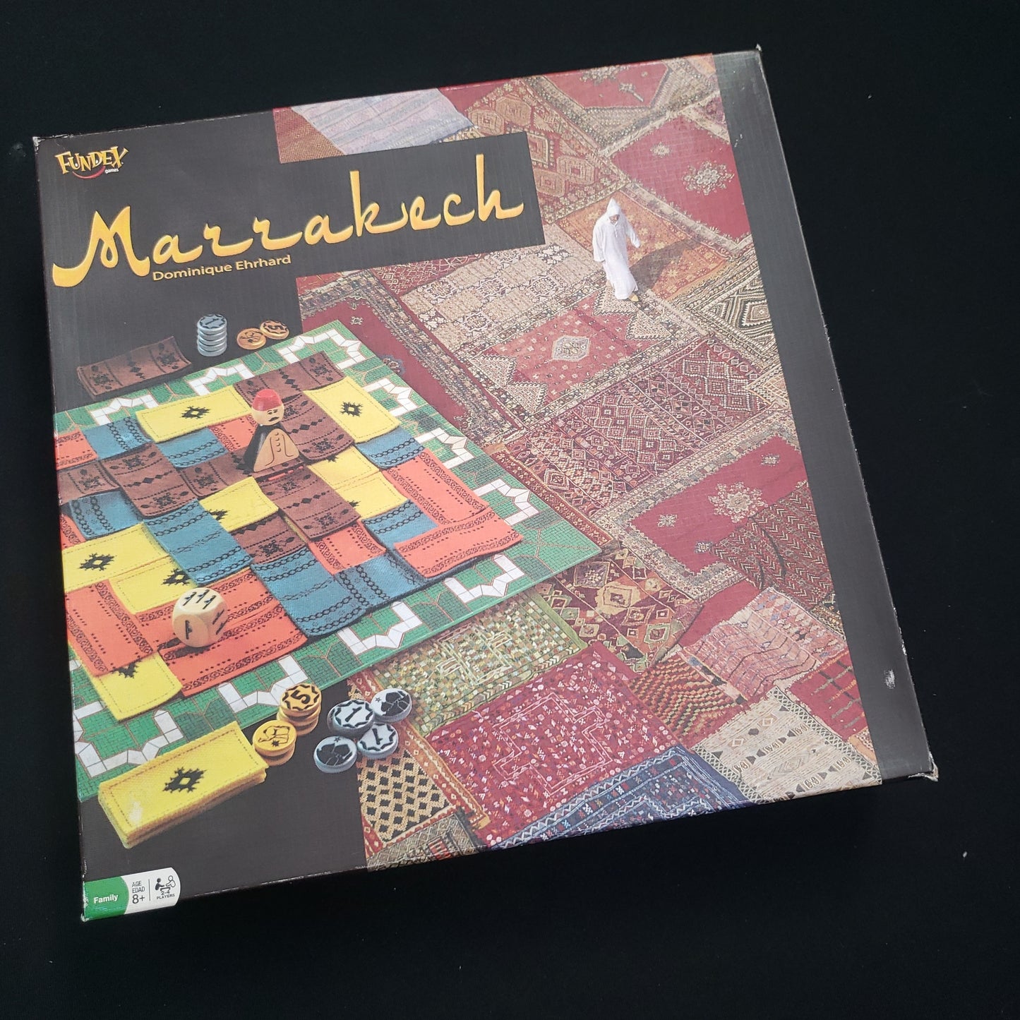 Image shows the front cover of the box of the Marrakech board game