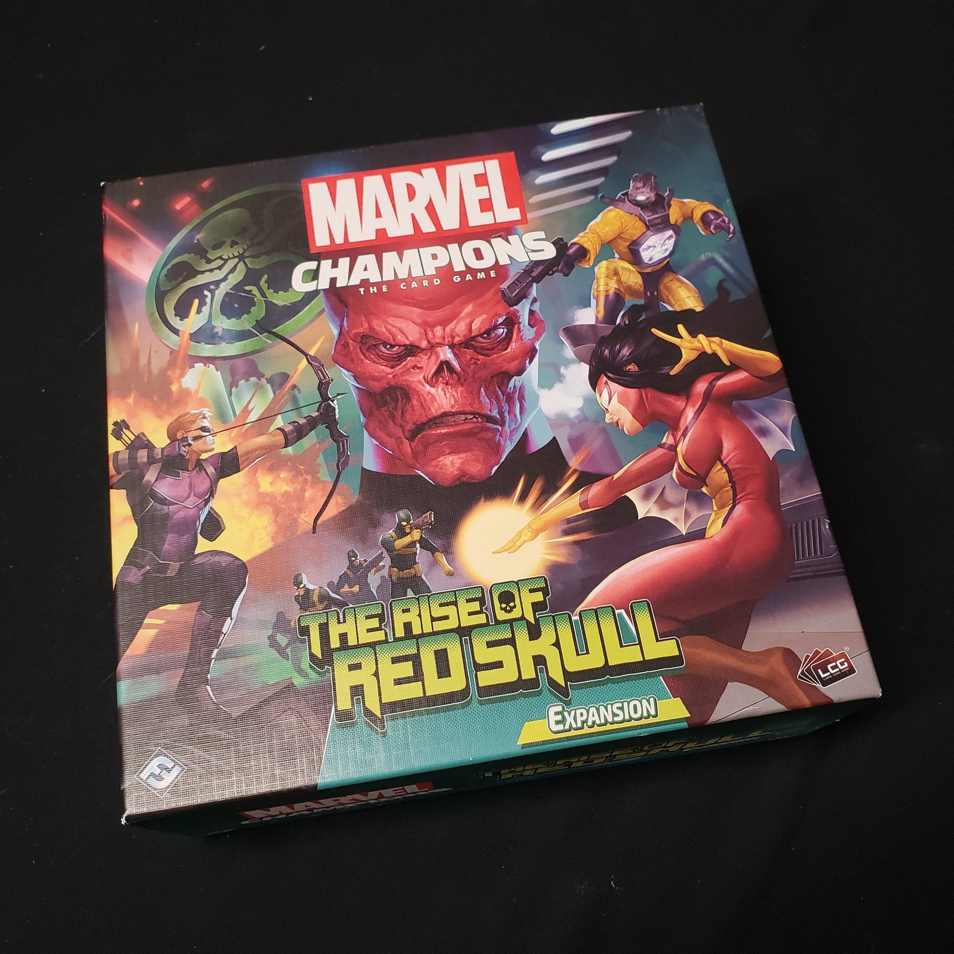 Image shows the front cover of the box of the Rise of Red Skull expansion for the card game Marvel Champions