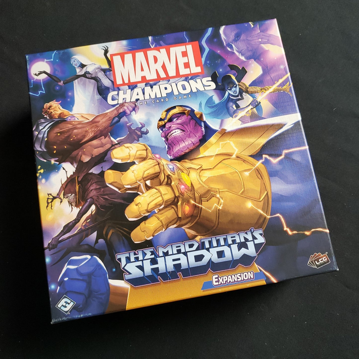 Image shows the front cover of the box of the Mad Titan's Shadow expansion for the Marvel Champions card game