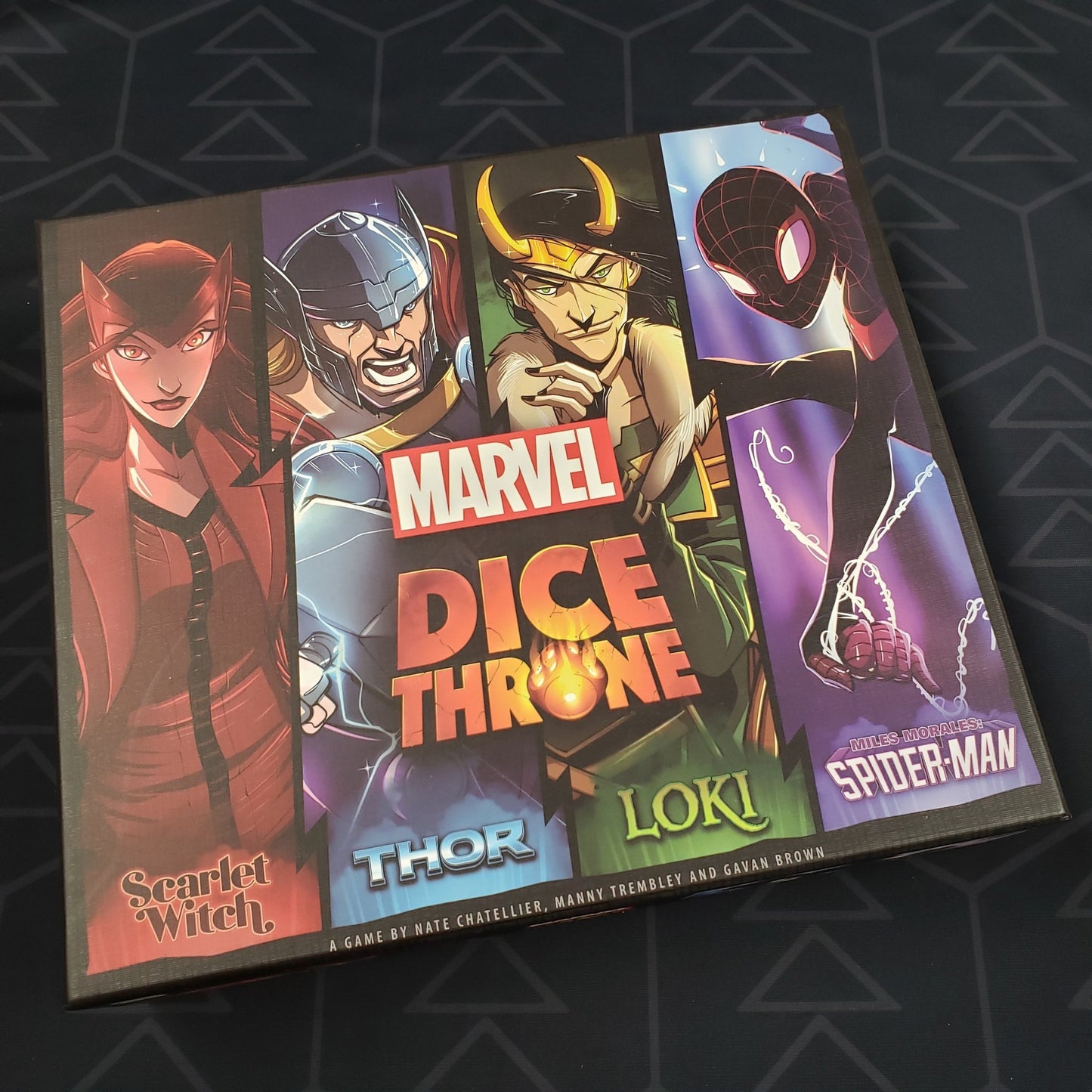 Image shows the front cover of the box of the Marvel Dice Throne: Scarlet Witch v. Thor v. Loki v. Spider-Man board game