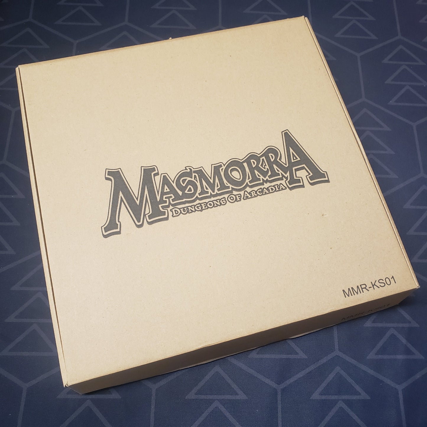 Image shows the front cover of the box of the Kickstarter Exclusives expansion for the board game Masmorra: Dungeons of Arcadia